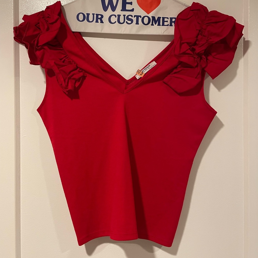 Sleeveless crop top with ruffle shoulders